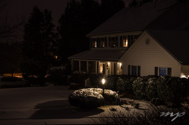 A neighbor's house on a snowy night.